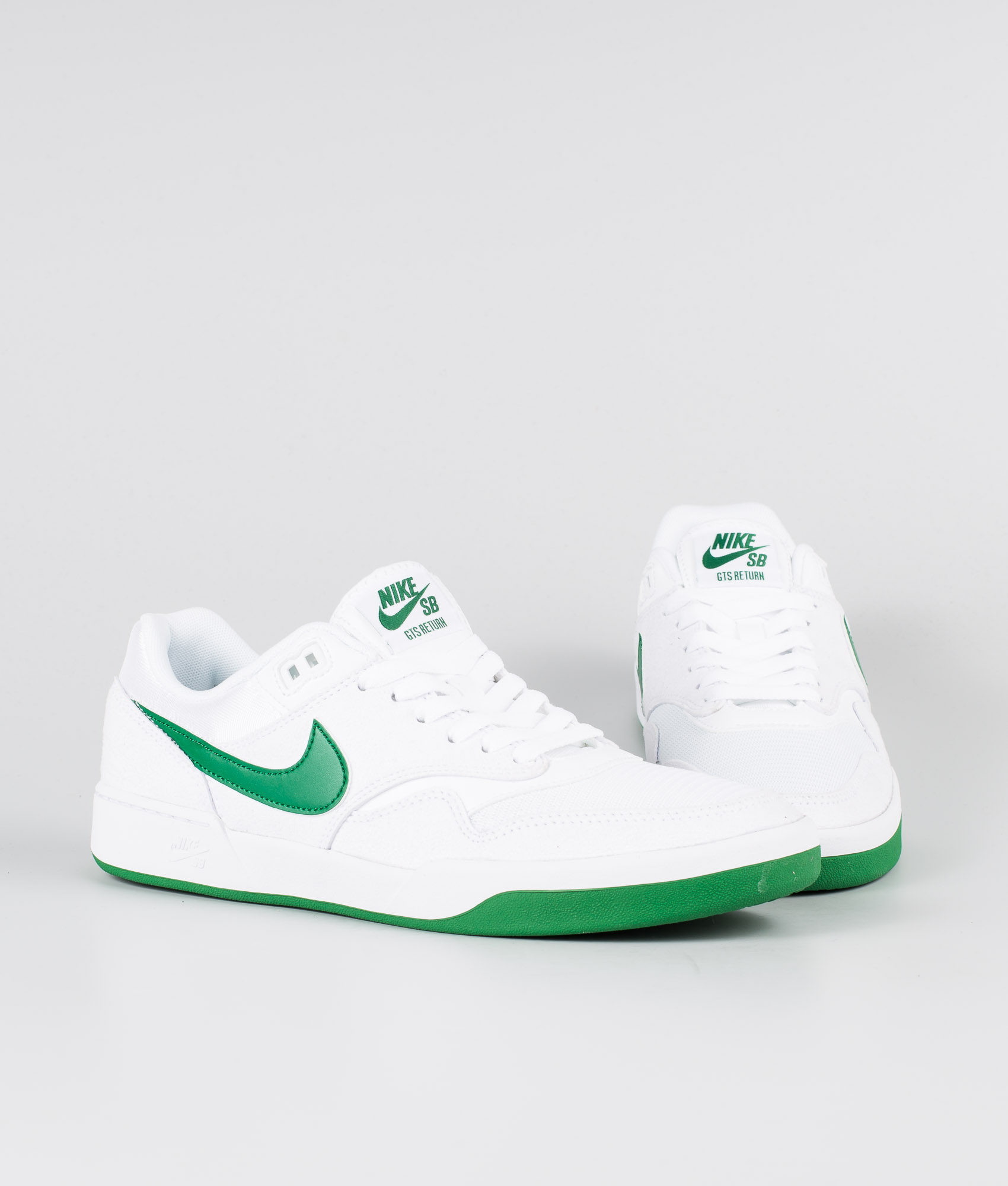 white and green nike shoes